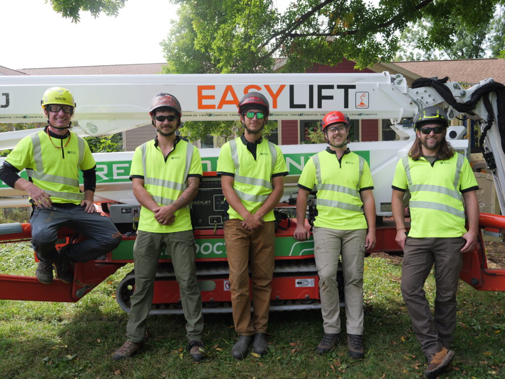 Eco Tree arborists standing in front of tree lift joyfully